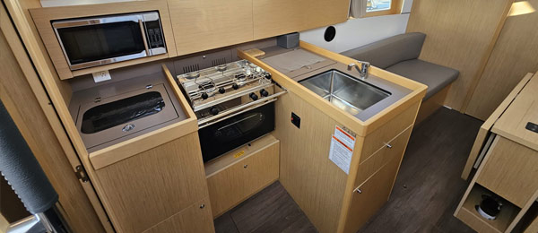 Interior of a modern RV with a kitchenette and seating area.