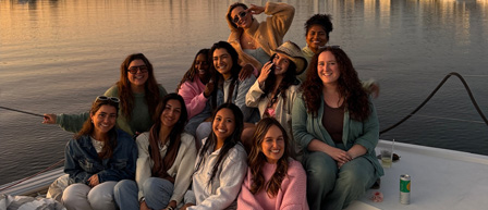 A group of women on a boat at sunset, enjoying their time with Seaforth Boat Rentals.