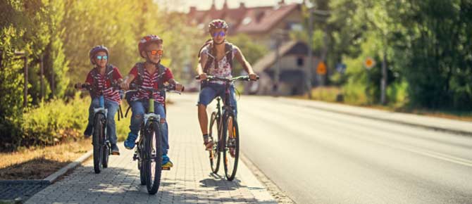 Children Riding Bikes on a Road