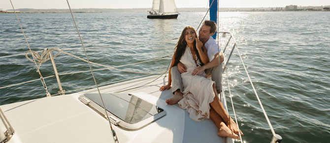 A happy couple sharing a romantic moment during a couples proposal on a luxury yacht bay cruise