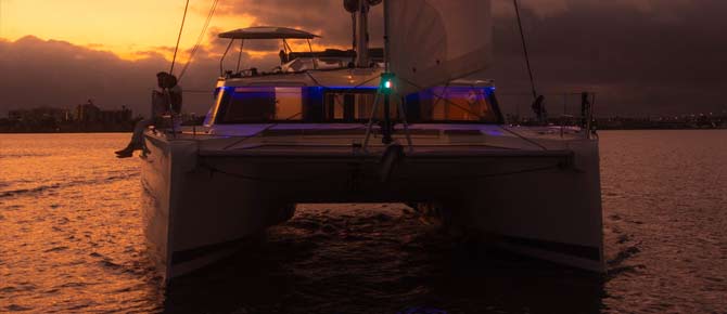 A couple embraces on a private yacht during proposal in a bay